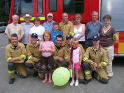 Pictured at St Columba�s Summer Fair and Car Boot Sale on Saturday 10th June is L to R:  (front row) Rebecca Cunningham and Tamzin Forbes with Lisburn Firefighters - Alan McCracken, Simon Davidson, Chris Veale, Patrick Agnew and Mark Stewart.  (back row) Isaac Cordner, George Stewart, Daphne Baxter, Jim Moore, Matthew Cunningham, Firefighter - Noel Kennedy, Shirley Graham, Rev John Honeyford and Joan Moore.