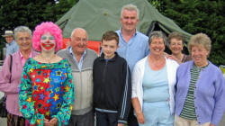 Pictured at St Columba�s Summer Fair on Saturday 10th June is L to R:  Annie Carlisle, Sharrie the Clown (Sharon Robinson), Robert, James and Alan Carlisle, Phyllis Woods, Joan Moore and Cathy Heron.