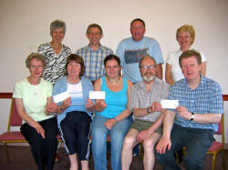 Pictured at the presentation of cheques at Magheragall Parish Church on Saturday 10th June is:  L to R: (front) Elizabeth Park, Gerardine Tolerton, Kerri Cunningham, and the Rector, the Rev Nicholas Dark. (back row) Gill Colvin, Ian Park, Bobby Cunningham and Sharon Cunningham.