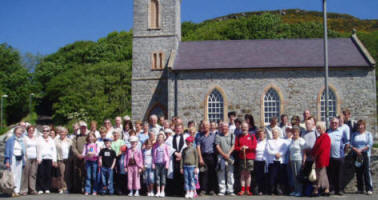 The Rev Nicholas Dark and members of the congregation of Magheragall Parish Church pictured at St Thomas, Rathlin, on Sunday 11th June.
