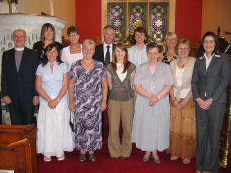 The Challenge Ethiopia Team 2006 pictured at a Commissioning Service in Ballinderry Parish Church last Sunday (25th June).  L to R:  (front row) Rev Canon Ernest Harris, Melinda Steele, Sandra Livingstone, Susanna Tuft, Heather Tuft, Ray Harris and Valerie Ellis � Team Leader (Crosslinks).  (back row) Jenna Boyd, Mona Thomas, Paul Hendron, Michael Hendron and Jill Hendron.  Missing from the photo: Rae Gamble and Kenny Clements