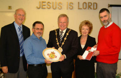 Church elder Stuart McDowall and church secretary George Allen, a member of the local music group �Slemish� are pictured passing on gifts that the band received from Spanish Cultural Ministers during the band�s trip to Spain on Monday 10th to Tuesday 16th October.  L to R:  John Miller, George Allen, the Mayor - Councillor Trevor Lunn, the Mayoress - Mrs Laureen Lunn and Stuart McDowall.  The picture was taken during morning worship in Lambeg Baptist Church last Sunday.