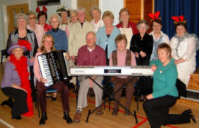 Norma Coggins (left) pictured with ladies from the congregation who provided the refreshments at the Senior Members� Christmas Tea in Railway Street Presbyterian Church on Saturday 2nd December.  Included in the photo are Jill Kilner (accordion), John Gordon (compere) and June Gordon (piano) who provided the musical entertainment.