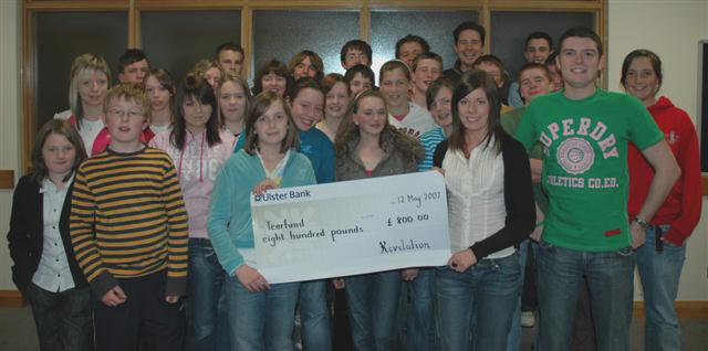 Members of Revelation (Youth Fellowship) belonging to St John's Parish Church, Moira, recently took part in a Sponsored Stay Awake, which raised '800 for Tearfund. Emma Louise Hayes (left) who raised the largest individual amount is pictured handing over the cheque to Tearfund representative Lois Finlay (right). Included are Simon Henry - Youth Ministry Co-Ordinator (right) and members and leaders of the Youth Fellowship who took part in the event.