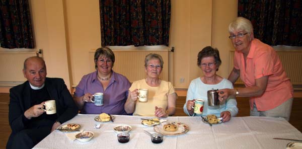 Sandra Rice is pictured serving tea and scones to past pupils Bell Macauley and Violet Spence (fourth from left) at Drumbo Presbyterian Church 'Drop In' centre. Violet was dinner lady at Drumbo Primary School in the 1960s and was caretaker and playground assistant in the 1970s and 1980s. Included in the photo are Rev Kenneth Smyth (former Chairman of the Board of Governors) and Mrs Hilary McCluggage (present Chair of the Board of Governors).