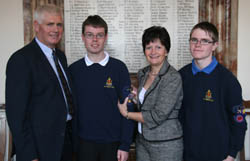 Rowan Davidson receives the Queen's Badge from his mother Beryl. Looking on is Rowan's father Tom and brother Jonathan. 