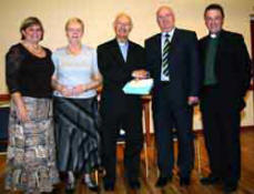 Canon Cochrane is presented with a gift on behalf of the congregation by Mr Wesley Dickinson - Rector?s Warden.  L to R:  Mrs Ann Elliott, Mrs Mildred Cochrane, Canon Cochrane, Mr Wesley Dickinson and the Rev Paul Dundas.