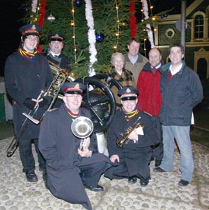 At the switch-on of the Christmas tree lights in Drumbo are (right of picture) Drumbo and District Community Association members Paul Gregg (Treasurer) and Ian Douglas (Chairman) with Councillor Betty Campbell and the Rev Adrian McLernon (Minister of Drumbo Presbyterian Church). Included in the photo are Salvation Army band members Nathan Moore and Adam Moore (left at back) and John Murdock and John Moore (kneeling at front).