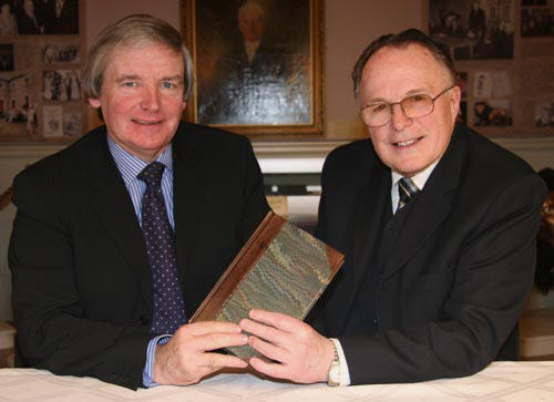 Joe Costley (Managing Director of JC Print) presents Dr John Douglas with a leather bound copy of his book.