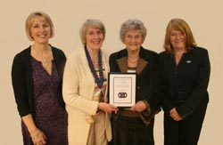Gertie Reid, President of Magheragall Women's Institute is picturing conferring honorary membership on Betty Totten, their longest serving member