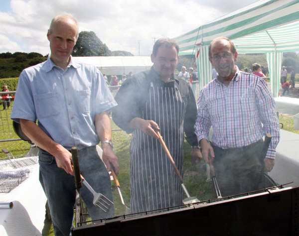 William Anderson, Simon Kennedy and David Blevins cooking up burgers for the 130 children who enjoying the Holiday Bible Club at Culcavey Hall.