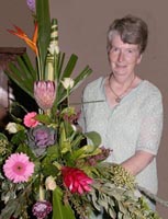 Violet Best adds the final touches to one of the many beautiful floral displays.