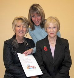 Graphic designer Sheila Jamieson shows the cover of �The Real Way to Plan The Year� to Carolyn Gowdy (left) and Jean Murray (right), members of Railway Street Presbyterian Church�s Fundraising Committee. 