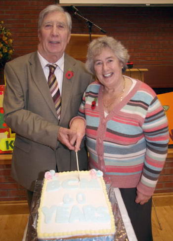 Tom McKinstry and his wife Joan cutting the 60th anniversary cake. 