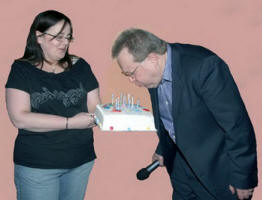 Pastor Brian Agnew blows out the candles on the 10th anniversary birthday cake. Looking on is Sharon Fleming.