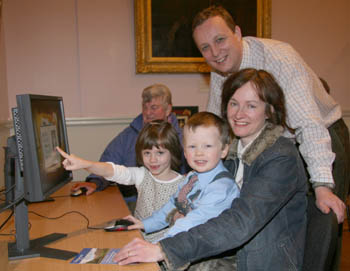 Donna Allen and her children Chloe (6) and Ethan (3) pictured at the interactive timeline showing the history of the Covenanters. Looking on is Joan Coates, assistant minister of Lisburn Reformed Presbyterian Church, who helped organise the display.