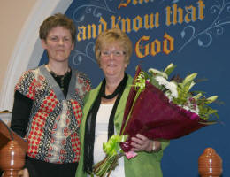 Mrs Hazel Hilland presents a bouquet of flowers to Mrs Margaret Morrison welcoming her to Carr Baptist.
