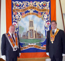 Bro Anthony Harvey (Worshipful Master) and former Lisburn man Bro John Nicholson (SW England Province Past Grand Master) pictured at the banner of Blaris Christ Church Temperance LOL No 128 at the District Orange Service in Christ Church on Sunday 12th July. 