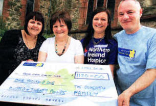Nicola Turtle, Pat Maguire and Lisa Murray handing over a cheque for £1,120, raised through a coffee morning in memory of Elizabeth Doherty, to Phil Kane from Marie Curie Cancer Care.