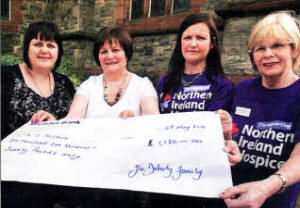 Nicola Turtle, Pat Maguire and Lisa Murray handing over a cheque for £1,120, raised through a coffee morning in memory of Elizabeth Doherty, to Ann McNally from Nl Hospice. US1810-522cd