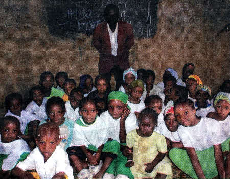 The children in class with their teacher.
	