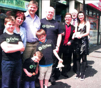 0xfam's Lisburn shop recently launched a drive for increased stock with a Donation Day event. From left: Sean Haire; Cllr Jenny Palmer; Benjamin Harrison (front); Basil McCrea MLA; Zach Kerr (front); Tony McMullan, Chairman of 0xfam lreland; lllusionist Paul 0rmonde; former Mayor of Lisburn Cllr Alan Ewart; and illusionist's assistant Sara Stevenson.