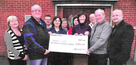 Roy and David Heasley present ICU Nurses Liz McAlea and Anne Graham from the Mater and Belfast City Hospital with a cheque for BHSCT (Belfast Health & Social Care Trust). US1411-406PM Pic by Paul Murphy