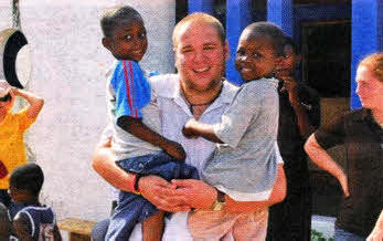 Andrew McMurray working with HIV Aids orphans in Ghana.