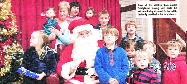 Some of the children from Anahilt Presbyterian making sure Santa felt welcome during his recent festive visit to the family breakfast at the local church. 
