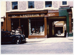 Smyth Patterson Ltd., Timber and Hardware shop in 1957.  Pictured outside is Haroldï¿½s Austin Ten car, and at the bottom of the entry is the timber yard.  The Lisburn city centre shop is now a modern ten-department store.