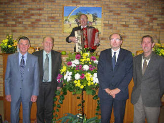 Ballymacbrennan School Hall leaders and guest speaker, pictured at the Harvest Service on Monday evening 6th November 2005.  L to R:  (front) David Adams, Norman Moore, Desmond Shortt and John Martin.  Standing at the pulpit is the Rev. Fred Greenfield - Minister of Newtownards Free Presbyterian Church.  In the background is a painting by the late Jack Calderwood, showing a harvest scene.