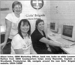 Alison Irvine, GBNI Marketing Officer, back row, looks on while Leeanne Railton from GBNI headquarters helps Jenny Reynolds, Captain of Woodlands Presbyterian GB, navigate around the new Girls' Brigade website. US34-745SP