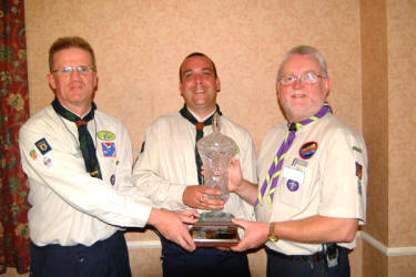 Davy Hilland - Assistant District Commissioner for Cubs is pictured being presented with the Jeff Fenning trophy for outstanding leadership by Noel Irwin (left) - Lisburn and District Scouts Commissioner and Richard Totten (right) - County Antrim Commissioner, at the Lisburn and District Scouts AGM on Wednesday 23rd August.