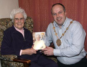 Isabel McArdle pictured with Lisburn Mayor, Councillor James Tinsley as she proudly displays her special 100th Birthday Card from the Queen.
