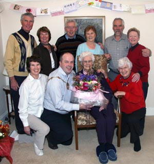 Isabel McArdle is pictured on her 100th birthday receiving a bouquet of flowers from Lisburn Mayor Councillor James Tinsley. Included are members of Isabelï¿½s family, some of whom travelled from as far afield as England, Canada and Australia to join with her on this special occasion.