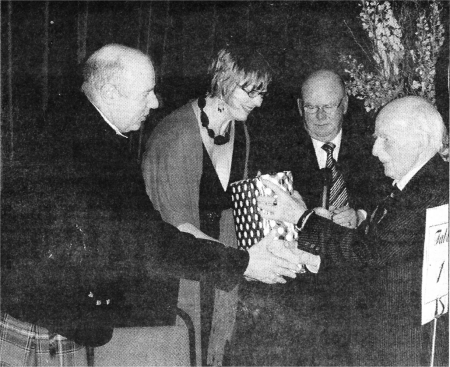 Former principals Mr Norman McClelland and Alderman Samuel Semple presenting present Mr Jim Sheerin and his wife with a gift.