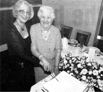President Sandra Dorman cuts the cake with founder member Betty Cowan. US2007-404PM