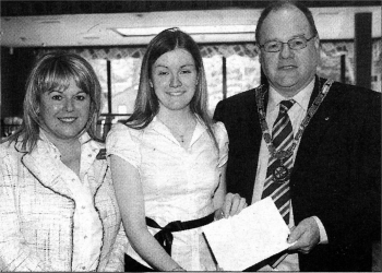 Helen Groves receives the Bursary from Ivan Conner President of Lisburn Rotary and Sandra McCabe, 2nd Vice President. US2107-106A0
