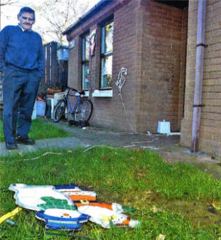 James McDermott looks at what is left after vandals stole his decorations. US4807-108A0