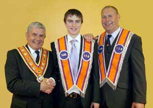 Br Adam McCahon, the newest member of Whitehill LOL 258, was initiated on Tuesday 1st July). Looking on are the Most Worshipful Robert Saulters (Grand Master) and his proud father, Br Kenny McCahon.