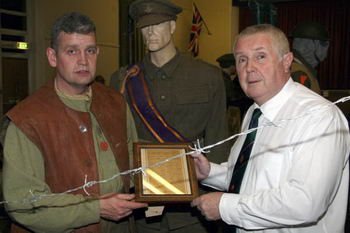 David McCallion (War Yearï¿½s Remembered) and Noel Kane (Somme Heritage Centre) pictured holding the signal sent in 1918 stating the end of the war.