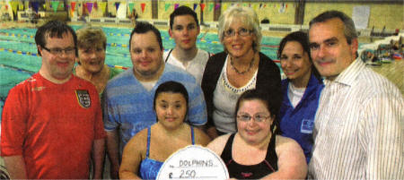 Receiving the Community Award from the director of Corus Ireland Chris Conway (right), are special athletes from the Dolphins group of the Lisburn 2gether Special Olympics, along with Chair of the group Lorraine Foster (back 3rd right) and Liz Ferguson, the Dolphins organiser.