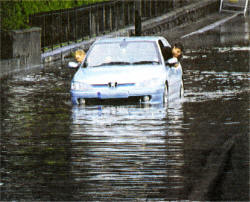 A car struggles to get through the flooded Moira Road. Pic by Robert Wilkinson.