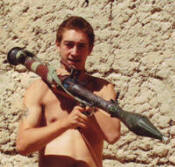 Phillip with an RPG, the weapon he was hit with in the Taliban attack.