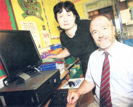 Local community worker Susan Kyle with Ian Thompson principal of Ballinderry Primary School who is against the idea of the school receiving wireless internet. US3408-119A0 Picture By: Aidan O'Reilly