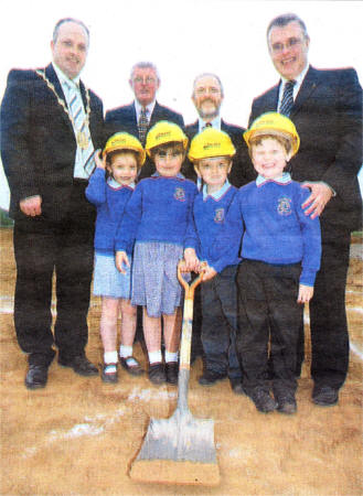 Ballinderry PS pupils Rachel Logan, Rebecca Hendron, Paul Wilson and Adam Black with Lisburn Mayor James Tinsley, Stanton Sloan Chief Executive of the SEELB, Principal Ian Thompson and Noel McKee Chairman of the Board of Governors cutting the sod at the site of the new school. US2208-115A0