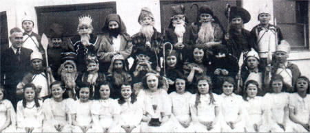 Children of Ballymacrickett Primary School get ready for the Christmas play with the then principal Mr Michael Fitzpatrick 11950's) prior to the school's annual Christmas play