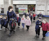 After a final gathering at the old Ballymacrickett Primary School, children leave for the last time to walk the short distance to their new multi-million pound state-of-the-art school, near Glenavy. US4708-579cd