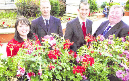 Ms Patricia Elliott, Lisburn City Centre Manager, Mr Mark Gregg, Parks Manager, Lisburn City Council, Alderman Edwin Poots, Deputy Mayor Lisburn City Council; and Alderman Paul Porter, Chairman of the Environmental Services Committee with one of the new floral displays.