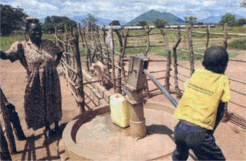 HOPE SPRINGS ETERNAL...Pumping fresh, clean, Oxfam-provided water in a camp in Madi-Opei transit camp, home to 2,000 people who are now making the move back to their own farms.